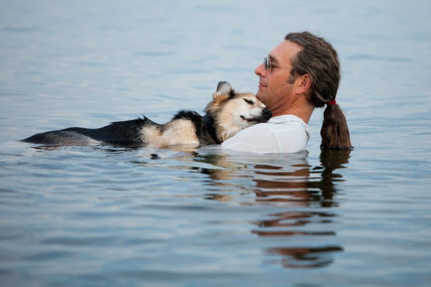man-in-lake-with-dog